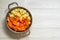 Close up, top view. Soup pot with sliced ingredients for pumpkin cream soup: carrot, pumkin, onion, potatoes.