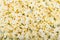 Close-up top view of white salted popcorn background