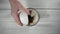 Close-up, top view, young woman`s hand pouring cocoa into blender