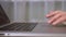 Close up touchpad and keyboard of laptop. Male fingers gestures at trackpad.