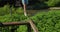 Close-up tourist hiker girl hands grabs on an old rusty tightrope across a mountain river