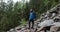 A close-up tourist looks at the landscape in rainy weather. Backpack