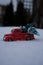 Close up of a toy pick up truck driving through the snow