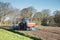 Close up of a tractor with an attached seed drill and fertilizer applicator for sowing maize