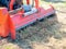 Close-up of a tractor with a chain mower chopping dry grass. Maintenance of the territory, mulching of grass, agricultural