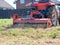 Close-up of a tractor with a chain mower chopping dry grass. Maintenance of the territory, mulching of grass, agricultural