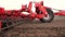 Close-up, tractor cultivator cultivates, digs the soil. tractor plows the field. automated tiller for digging soil in