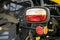 Close up of tractor headlight and cataphot, selective focus. Tractor red and orange lights against the background of the details