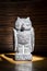 Close up of traditional bolivian owl statuette isolated on wooden background. Vertical Image