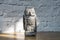 Close up of traditional bolivian owl statuette  on white brick wall