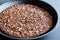 Close up of traditional castagnaccio cake, a classic italian gluten free autumn cake on wooden table made with chestnuts flour,