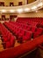 Close-up of traditional, classic empty chairs upholstered in red velvet, the interior of the theater