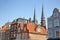 Close-up on traditional facades on the main square Markt with the spires of Maria van Jesse Kerk in the background, Delft