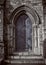Close-up of traditional gothic medieval wooden entrance doorway with ancient brick arc, mystical portal