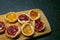 Close up of traditional home made rustic looking Jam and lemon Tarts on wooden chopping board.