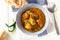 Close up traditional Indian butter chicken curry served with chapati bread in bowl. Top view