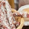 Close-up of traditional italian tasty delicacies in wicker basket, picant organic salami in the market. Gastronomic