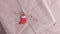 A close-up of a traditional New Year\\\'s toy in the form of a Christmas red sock decorates a festive kraft paper parcel.