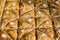 Close up of traditional oriental sweet pastry cookies known as backlava, Turkish desert with sugar, honey, walnuts and pistachio,