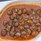 Close up of traditional spanish Tapas - the boiled Snails in tomato sauce with garlic and chili