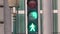 Close up of a traffic light, with the numbers counting down and a walking man