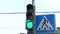 Close-up of a traffic light pedestrian crossing, the traffic light switches from green to red. City street at daytime.