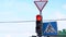 Close-up of a traffic light pedestrian crossing, the traffic light switches to red. City street at daytime.