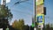 Close-up of traffic lights and road signs at an intersection in the city. Green traffic light. Urban road infrastructure