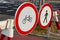 Close up of traffic signs on road barrier prohibiting people and bicycles going forward