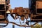 Close up of train wheels and break system in motion on track on wooden train bridge