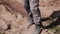 Close-up of a tramp walking through the desert with a bandage on his face