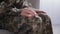 Close up of trembling female hands, unrecognizable woman soldier suffering from tremor after getting back from army