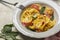 Close-up of trendy two-tonned stuffed italian pasta - tortelloni with ricotta
