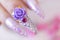 Close up trendy woman hand manicure with long acrylic extension stiletto style painting sweet ombre pink glitter decorated with