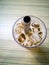 Close up on a tumbler glass full of iced coffee with a reusable metal drinking straw.