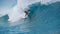 CLOSE UP Turquoise water splashes wildly behind fearless surfer riding in Tahiti