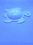 Close-up of a turtle, a symbol of longevity, wisdom and protection on an abstract classic blue background