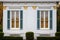 close-up of twin windows on a greek revival facade