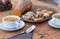 Close-up of two bowls of pumpkin cream soup. In the middle of the wooden table bread croutons