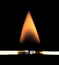 Close-up of two burning matchsticks on a black background