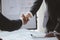 Close-up two business men holding hands, Two businessmen are agreeing on business together and shaking hands after a successful