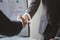 Close-up two business men holding hands, Two businessmen are agreeing on business together and shaking hands after a successful