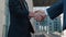 Close-up of two businessmen shake hands when meeting, agree to a deal or say hello. Handshake of two successful