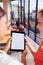 Close Up Of Two Businesswomen Looking At Digital Tablet In Shared Office Workspace