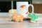 Close-up of two cookies with varied shape next to a small mug of milk