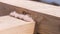 Close up of two crossed wooden beams for building a house under the bright sun. Clip. Part of wooden building