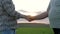 Close Up Of Two Farmers Businessmen Hand Shake Background Of Rural Green Field