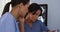 Close up of two female doctors using tablet and mobile phone