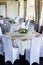 Close up of two festive tables setting with wine glasses, and fresh flowers