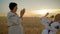 Close-up, Two Gay Women Clap their Hands and Laugh at the Wheat Field at Dawn